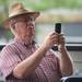South Lyon resident Bob Devereaux takes a photo of Dr. Mike and the Sea Monkeys performs during the AnnArbor.com Summer Concert Series on Friday afternoon. Melanie Maxwell I AnnArbor.com